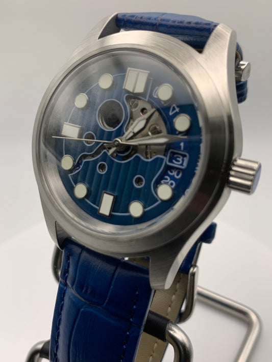 Wintermute. 39mm brushed stainless steel case. Domed sapphire crystal. Seiko NH35 with blue date wheel.