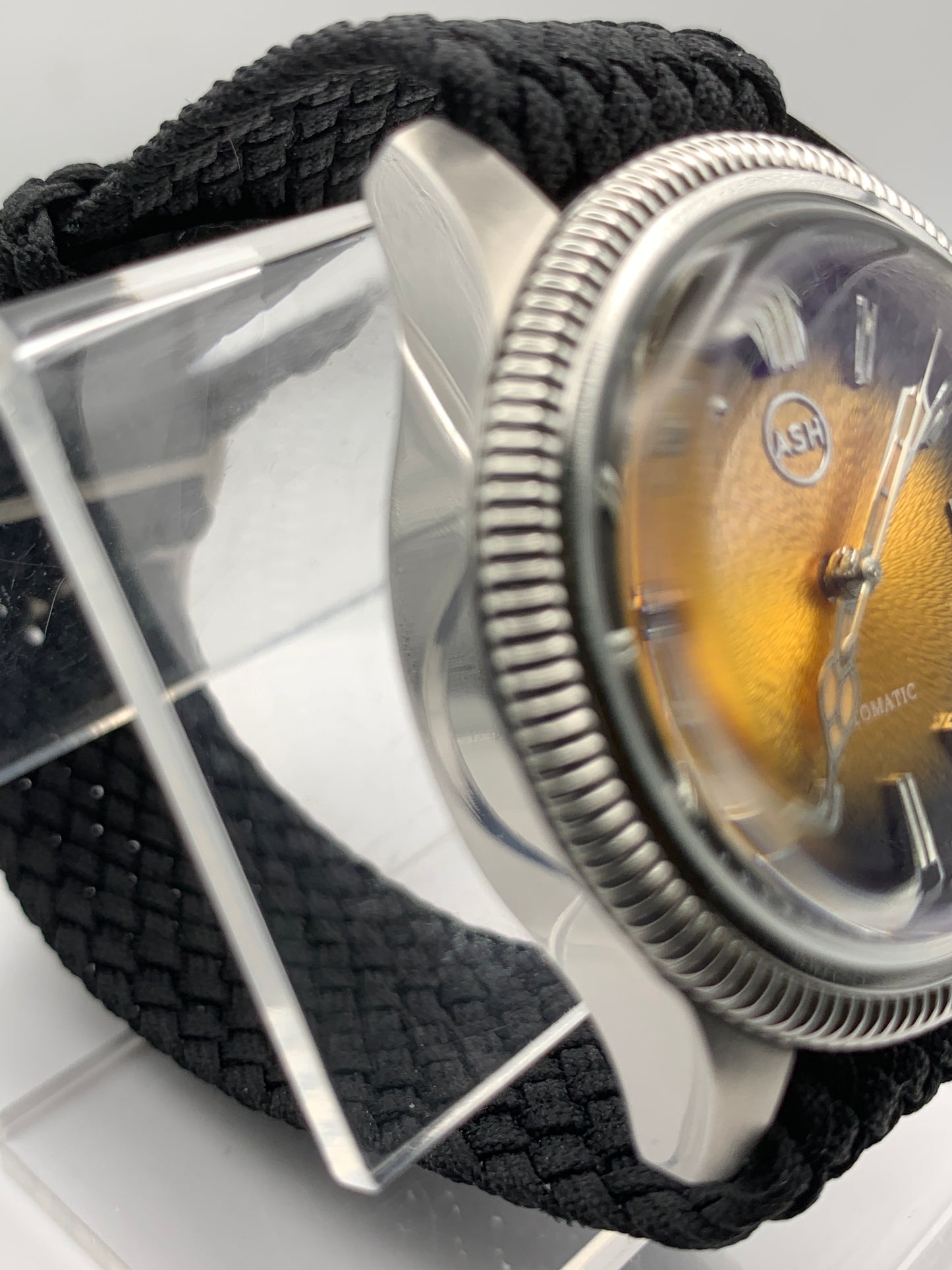 Homesick. 39mm Coin edged stainless steel case. Tobacco sunburst figured dial. AR coated domed mineral glass crystal. Seiko NH35 automatic movement.