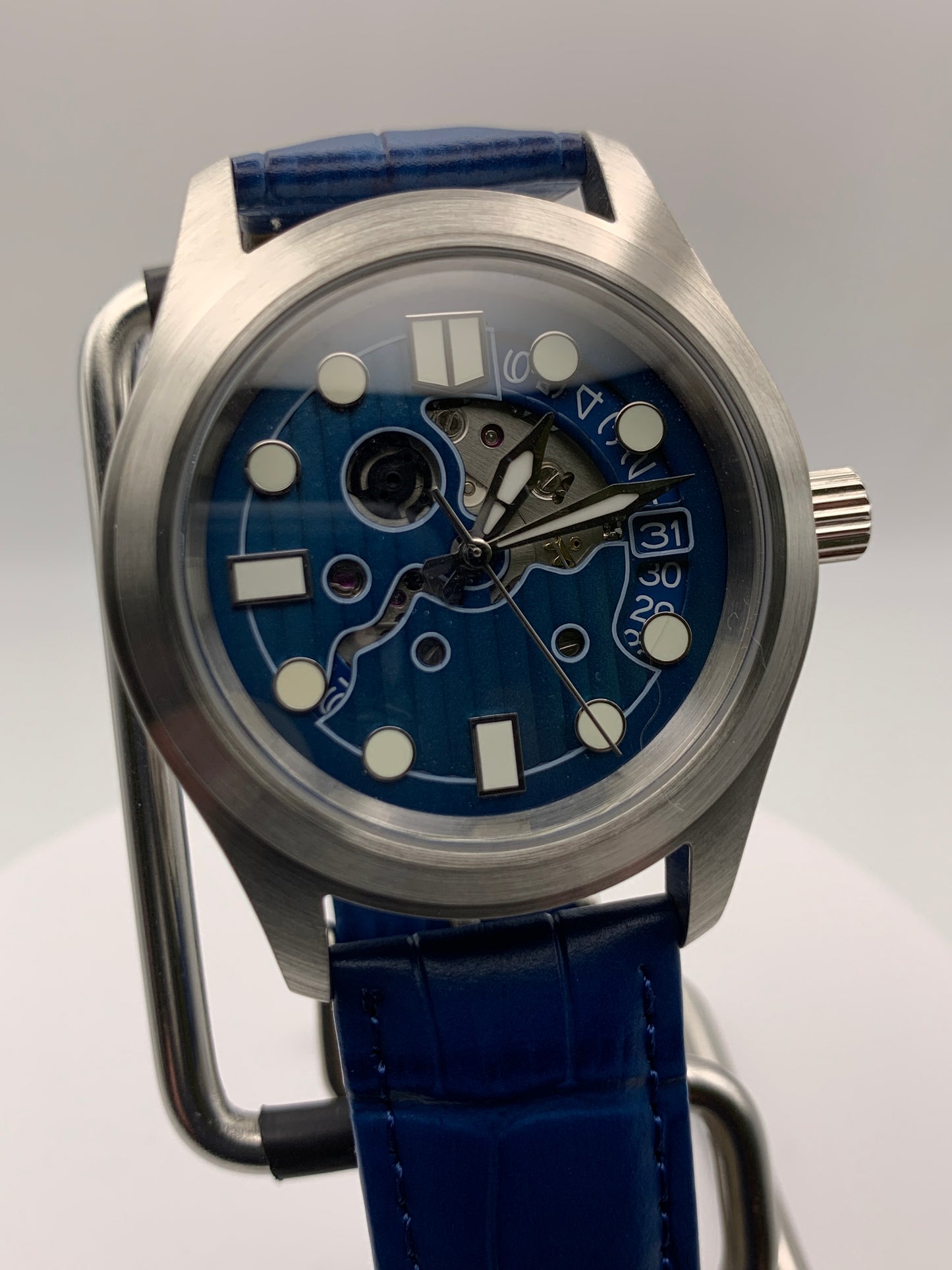 Wintermute. 39mm brushed stainless steel case. Domed sapphire crystal. Seiko NH35 with blue date wheel.