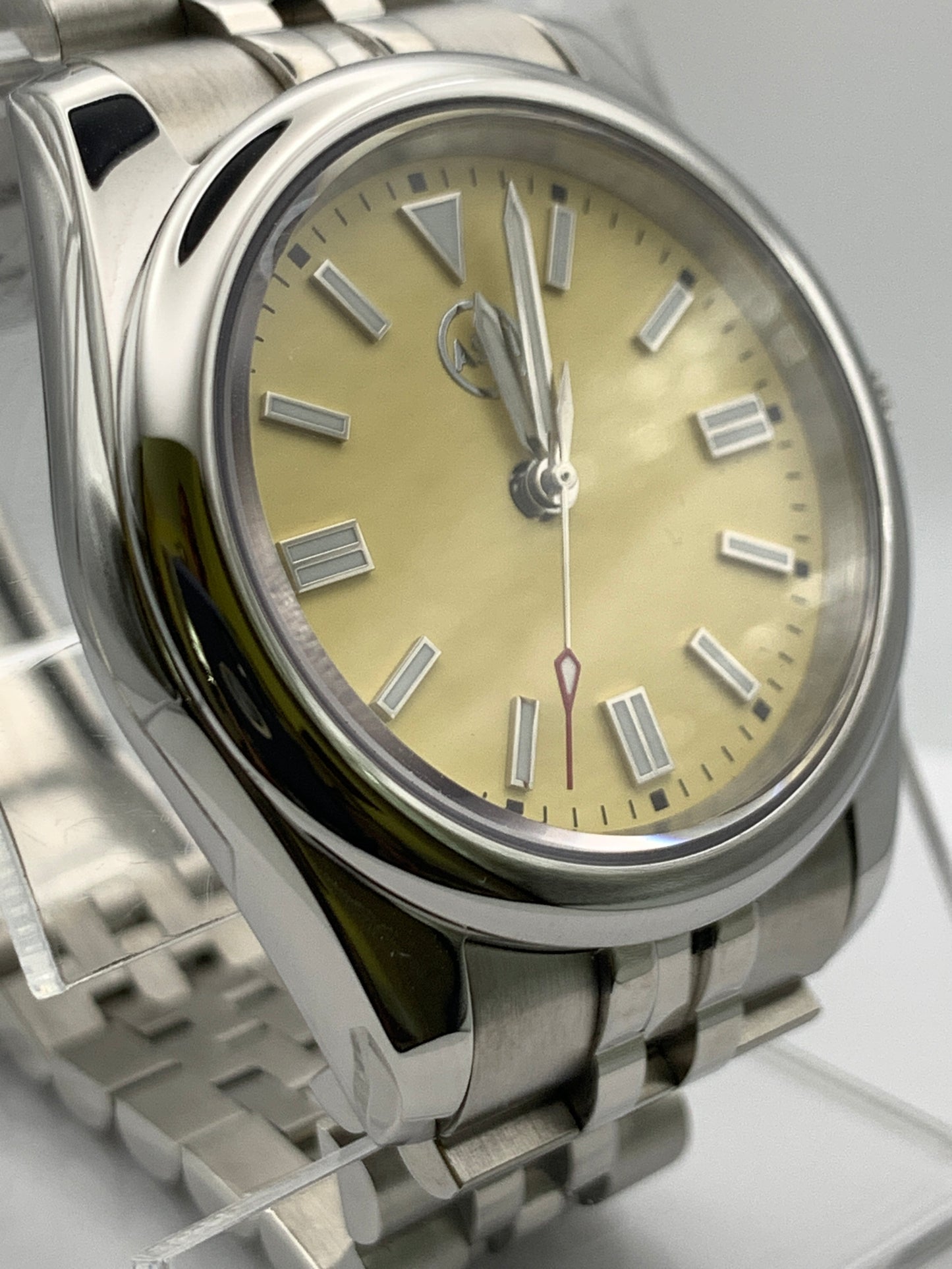 Pale yellow 36mm sport watch on bracelet.