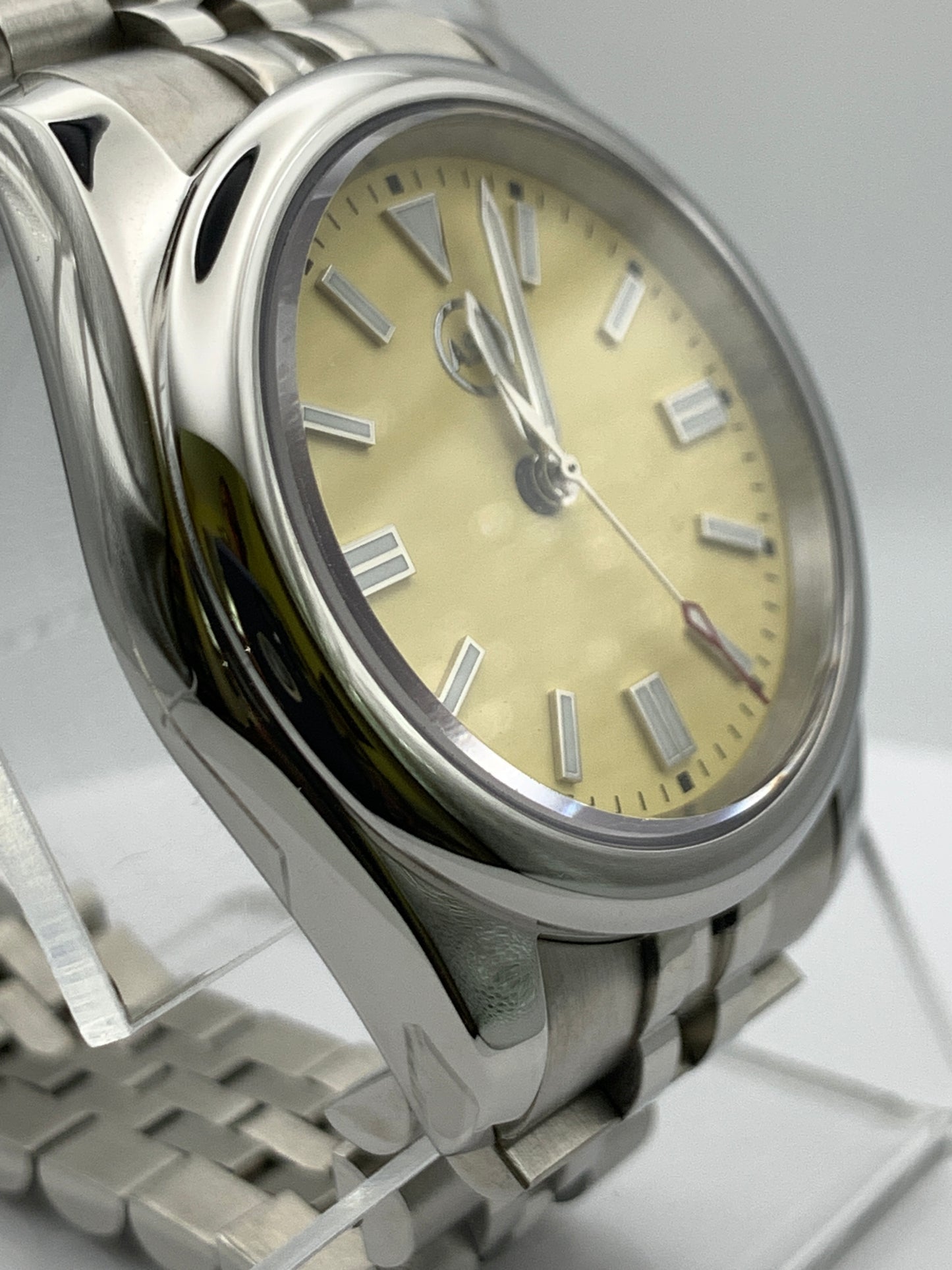 Pale yellow 36mm sport watch on bracelet.