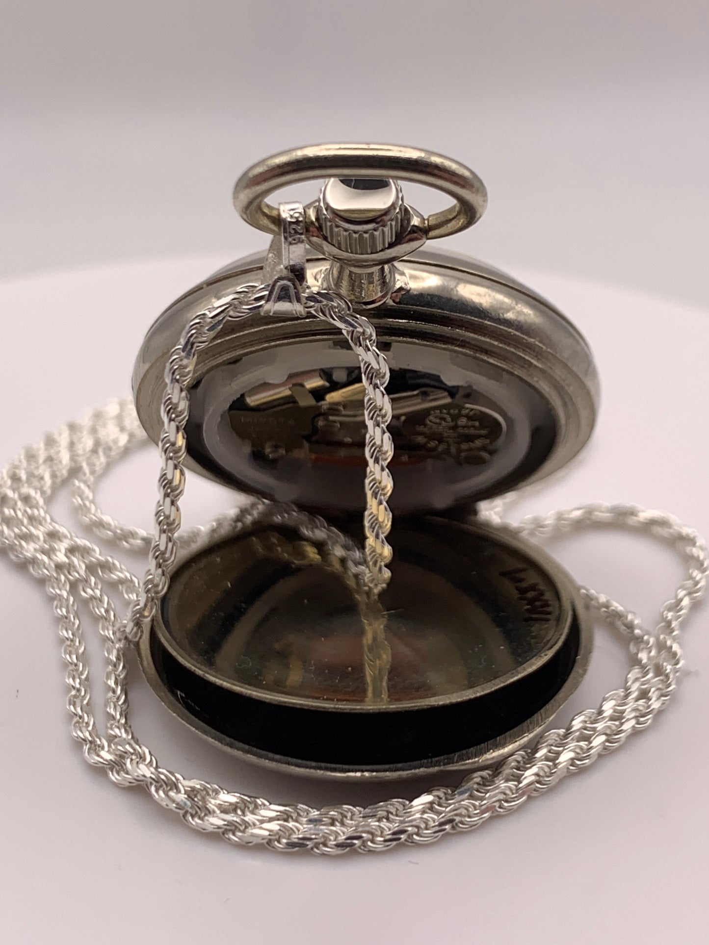 Amuse-bouche Deux. 30mm NOS Argentan alloy pocket / necklace watch. On a 24” 1.5mm sterling silver chain. Sapphire crystal. Vintage hand painted enamel dial. Miyota 2036.