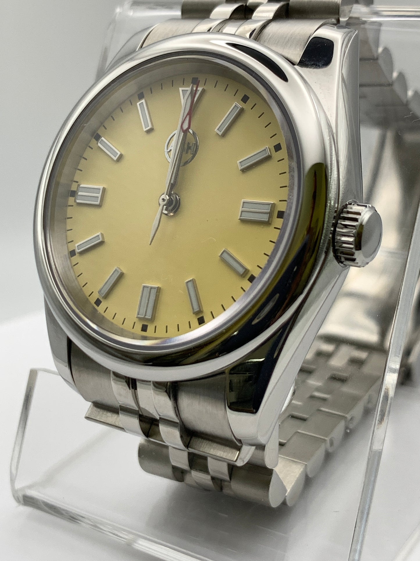 Pale yellow 36mm sport watch on bracelet.