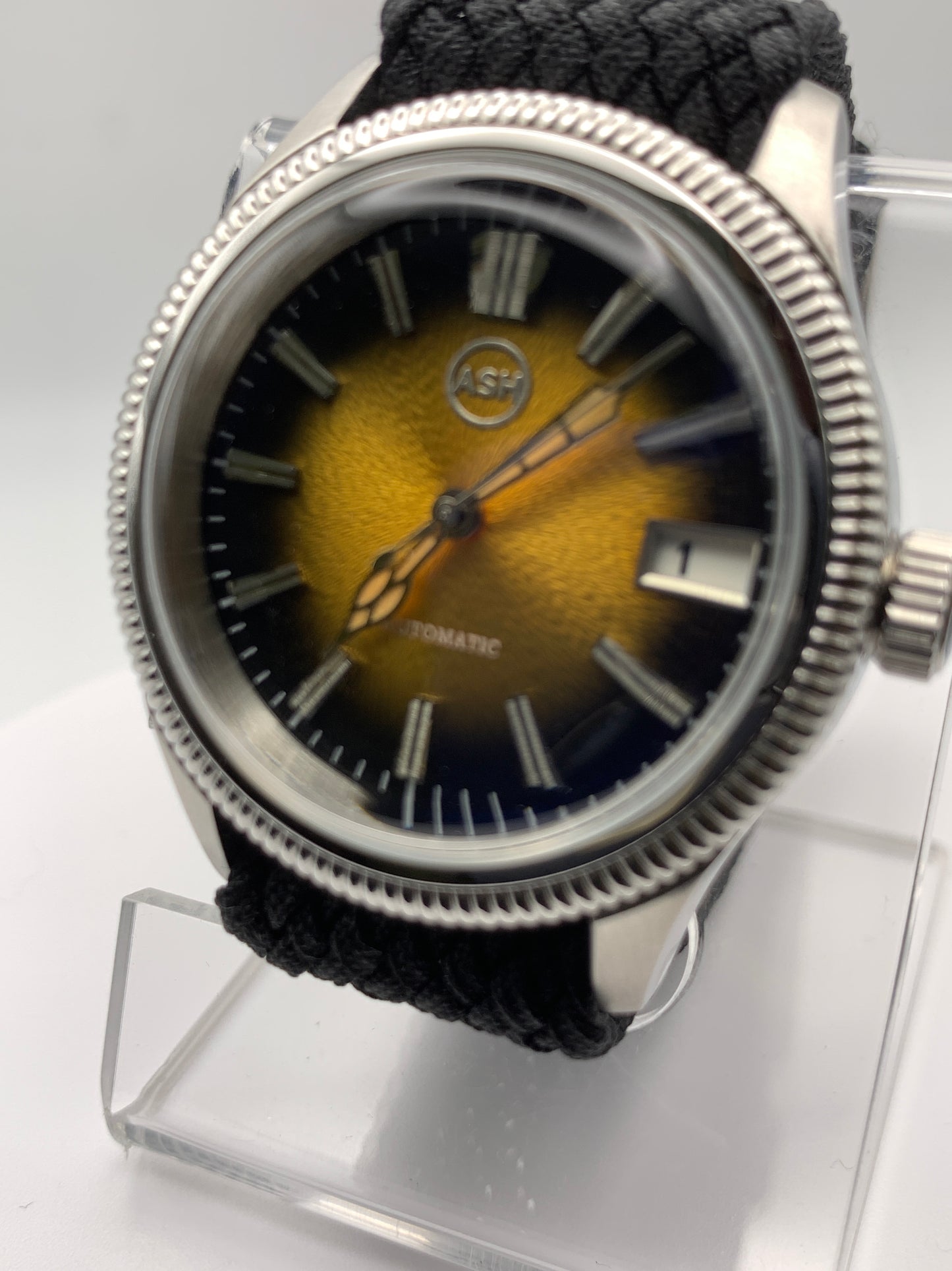 Homesick. 39mm Coin edged stainless steel case. Tobacco sunburst figured dial. AR coated domed mineral glass crystal. Seiko NH35 automatic movement.