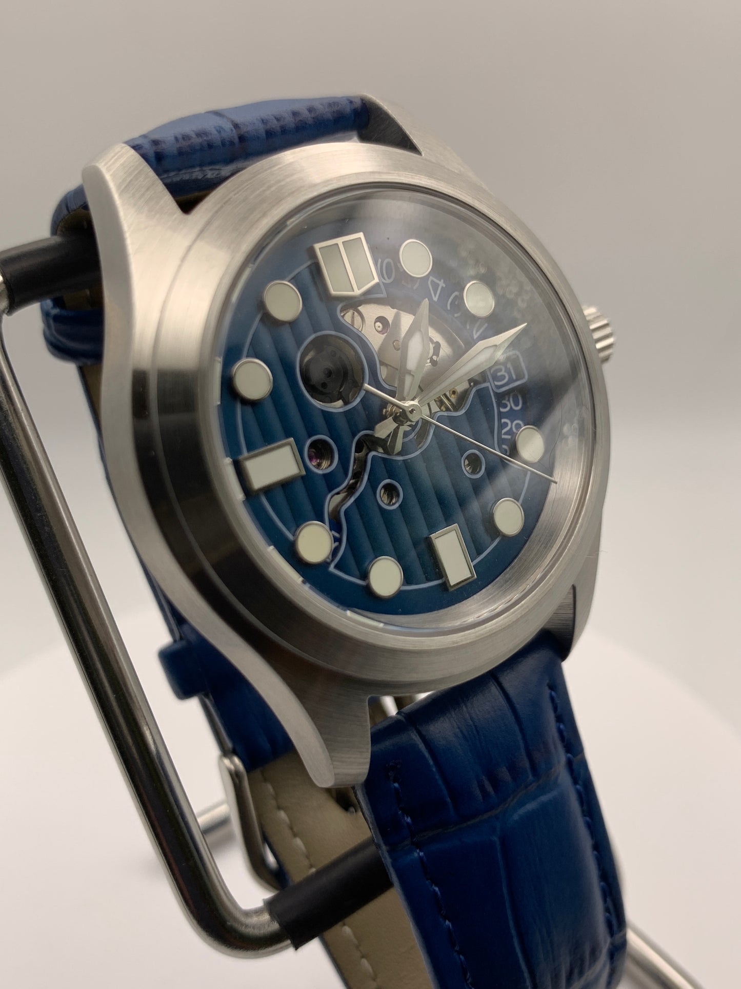Wintermute. 39mm brushed stainless steel case. Domed sapphire crystal. Seiko NH35 with blue date wheel.