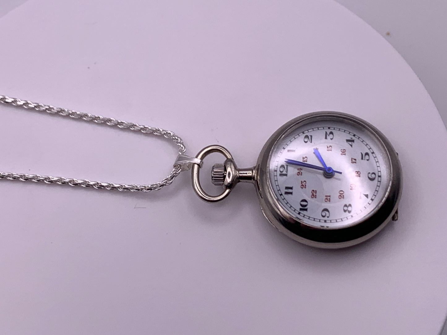 Amuse-bouche Deux. 30mm NOS Argentan alloy pocket / necklace watch. On a 24” 1.5mm sterling silver chain. Sapphire crystal. Vintage hand painted enamel dial. Miyota 2036.