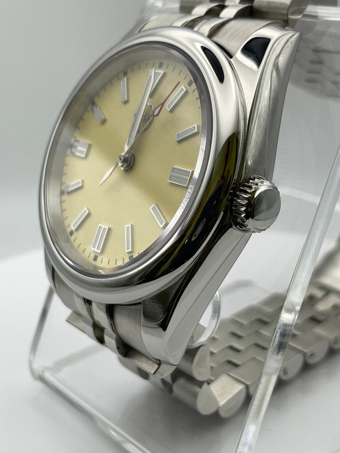Pale yellow 36mm sport watch on bracelet.