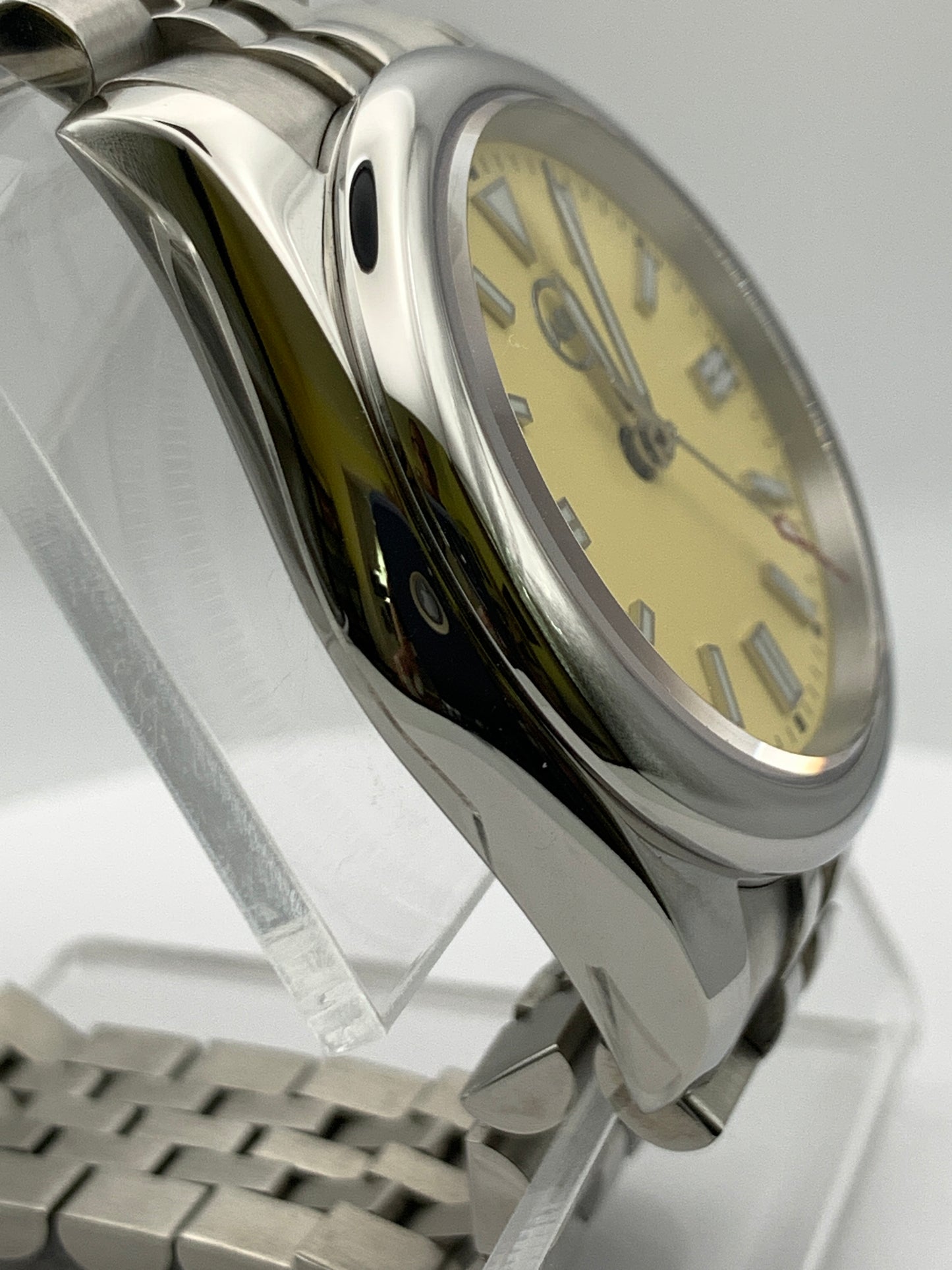 Pale yellow 36mm sport watch on bracelet.