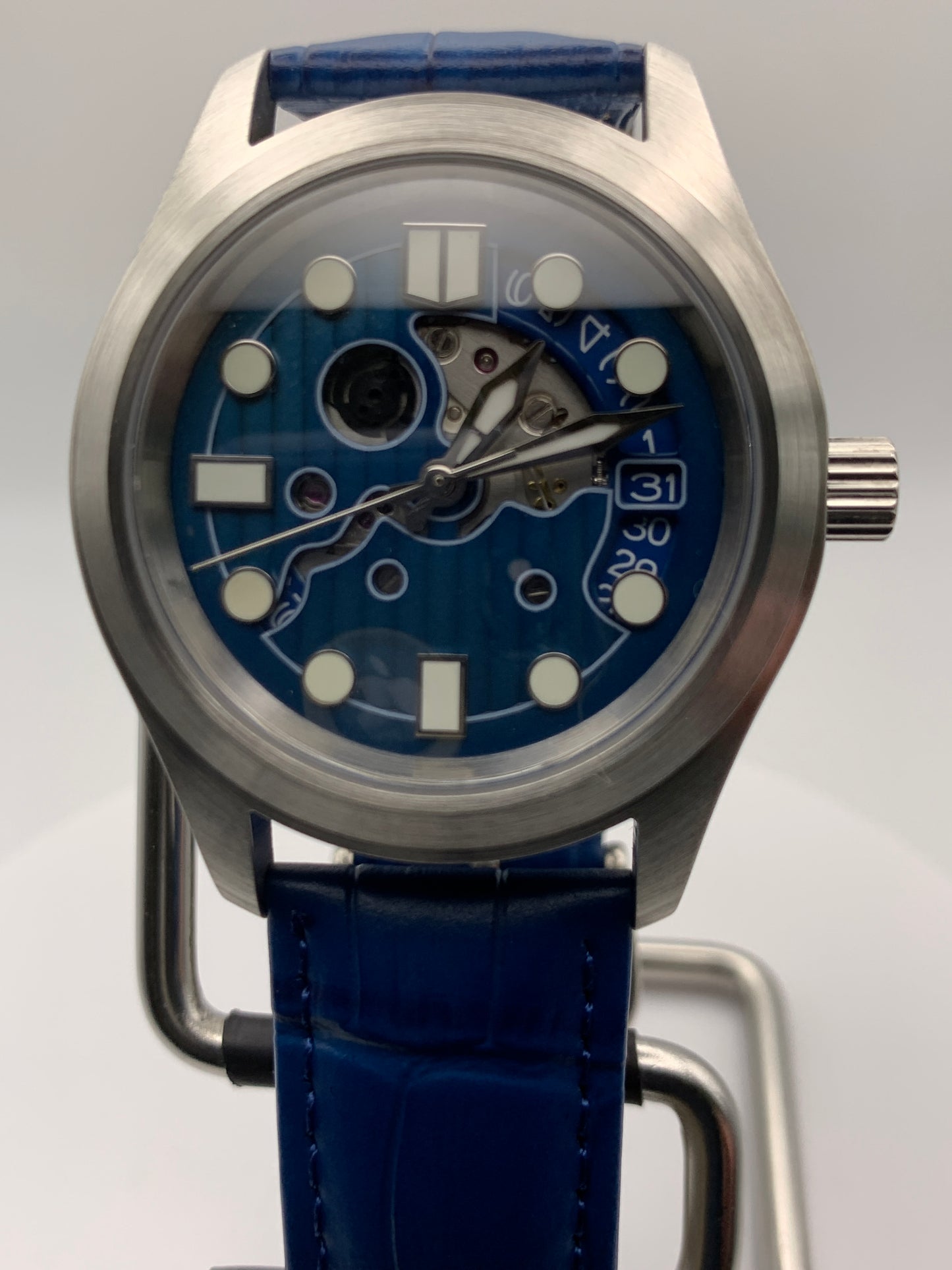 Wintermute. 39mm brushed stainless steel case. Domed sapphire crystal. Seiko NH35 with blue date wheel.