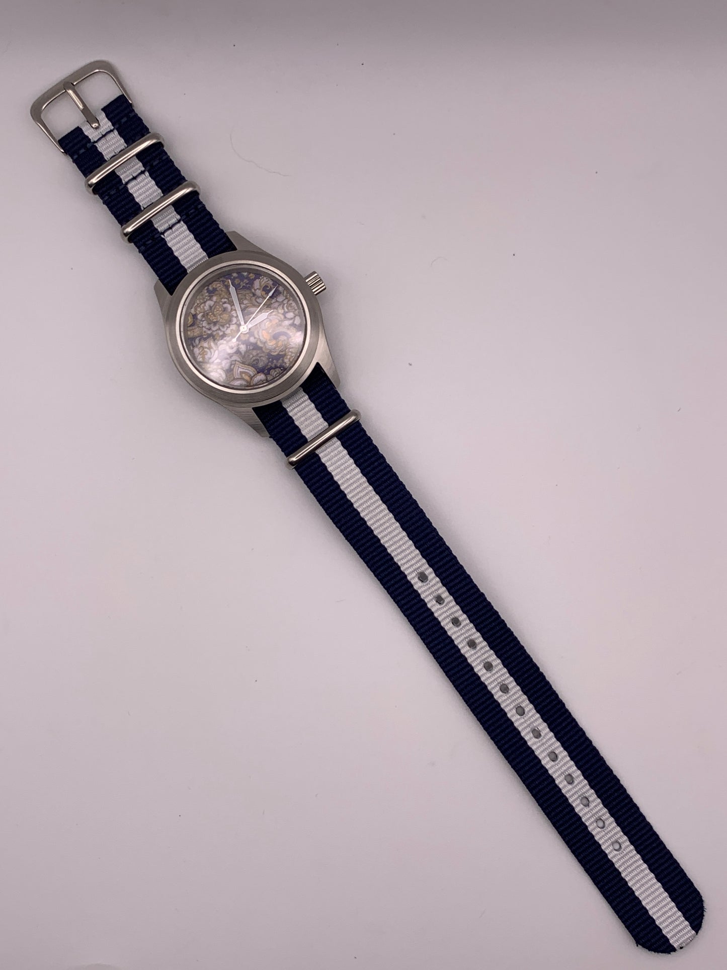 Cloth & Steel. 38mm brushed stainless steel. Ornate dial. Sapphire crystal. Seiko NH38