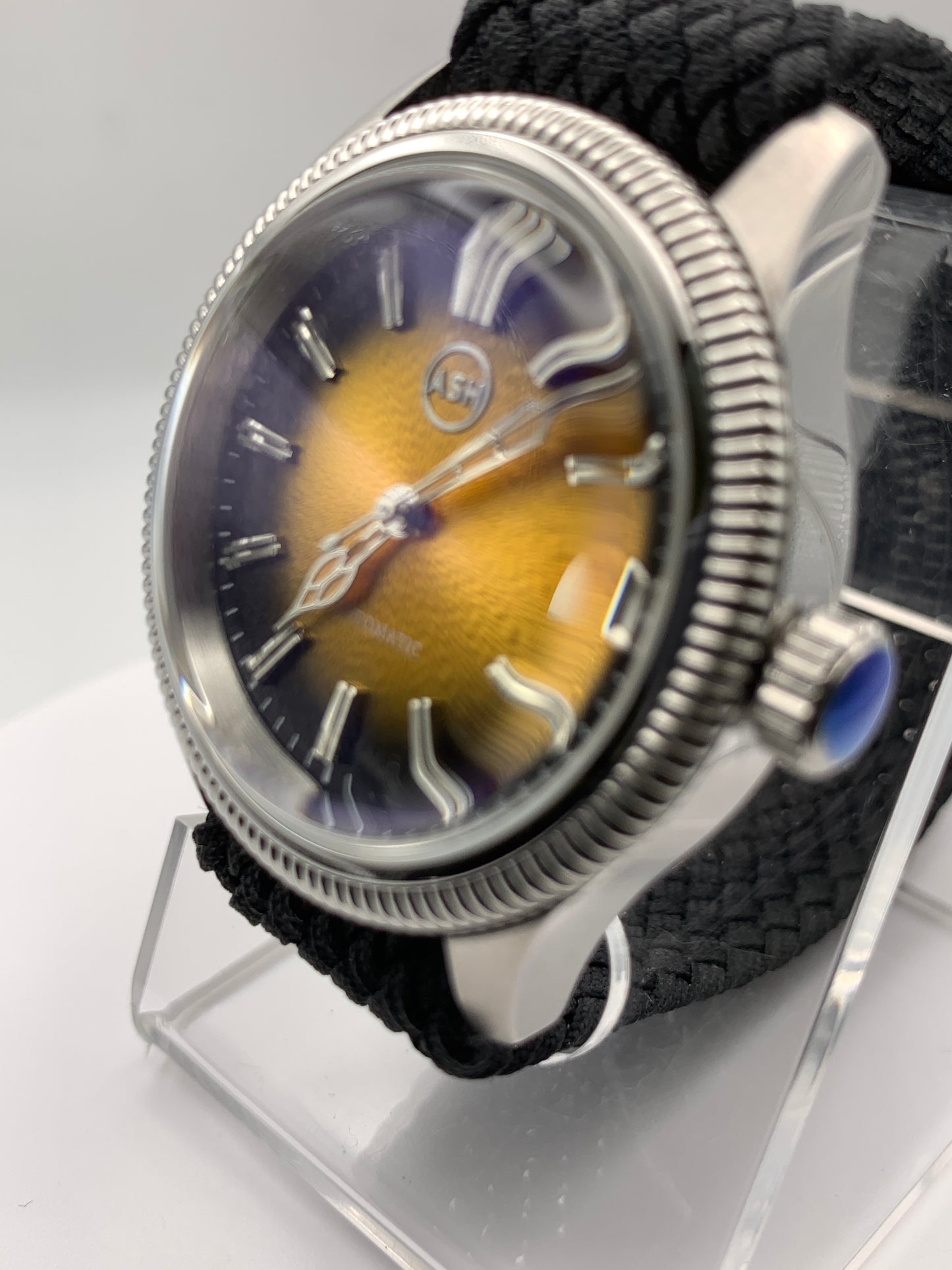 Homesick. 39mm Coin edged stainless steel case. Tobacco sunburst figured dial. AR coated domed mineral glass crystal. Seiko NH35 automatic movement.