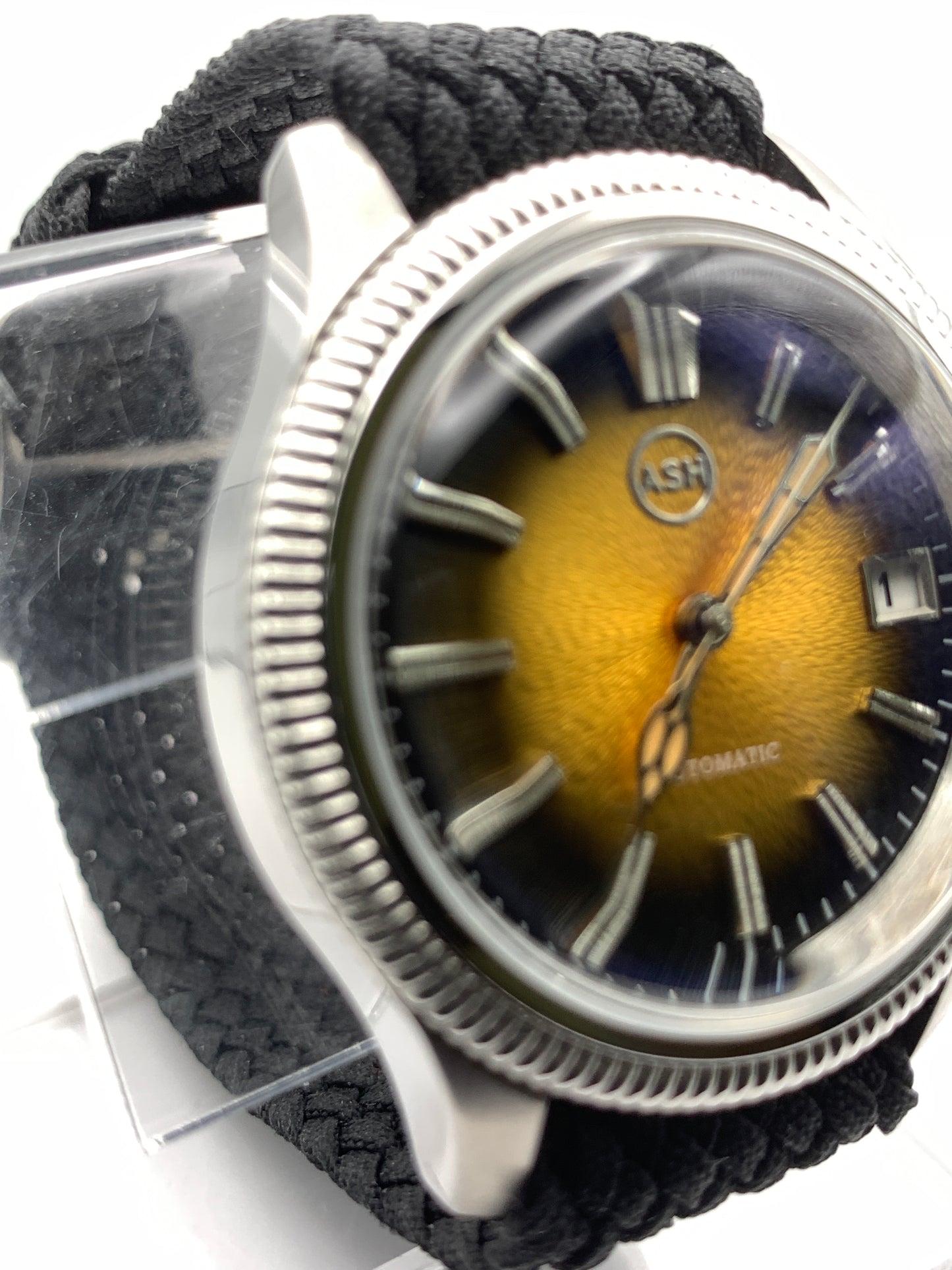 Homesick. 39mm Coin edged stainless steel case. Tobacco sunburst figured dial. AR coated domed mineral glass crystal. Seiko NH35 automatic movement.