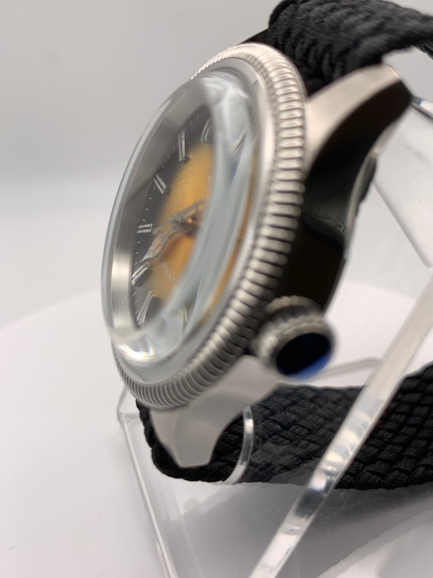 Homesick. 39mm Coin edged stainless steel case. Tobacco sunburst figured dial. AR coated domed mineral glass crystal. Seiko NH35 automatic movement.