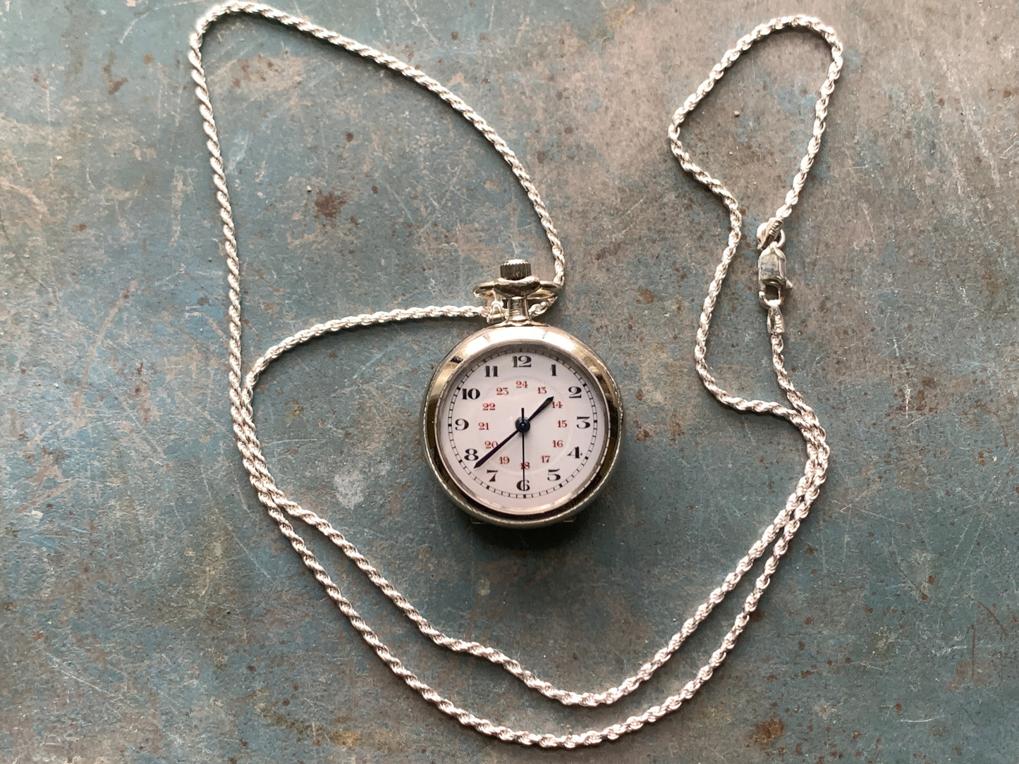 Amuse-bouche Deux. 30mm NOS Argentan alloy pocket / necklace watch. On a 24” 1.5mm sterling silver chain. Sapphire crystal. Vintage hand painted enamel dial. Miyota 2036.