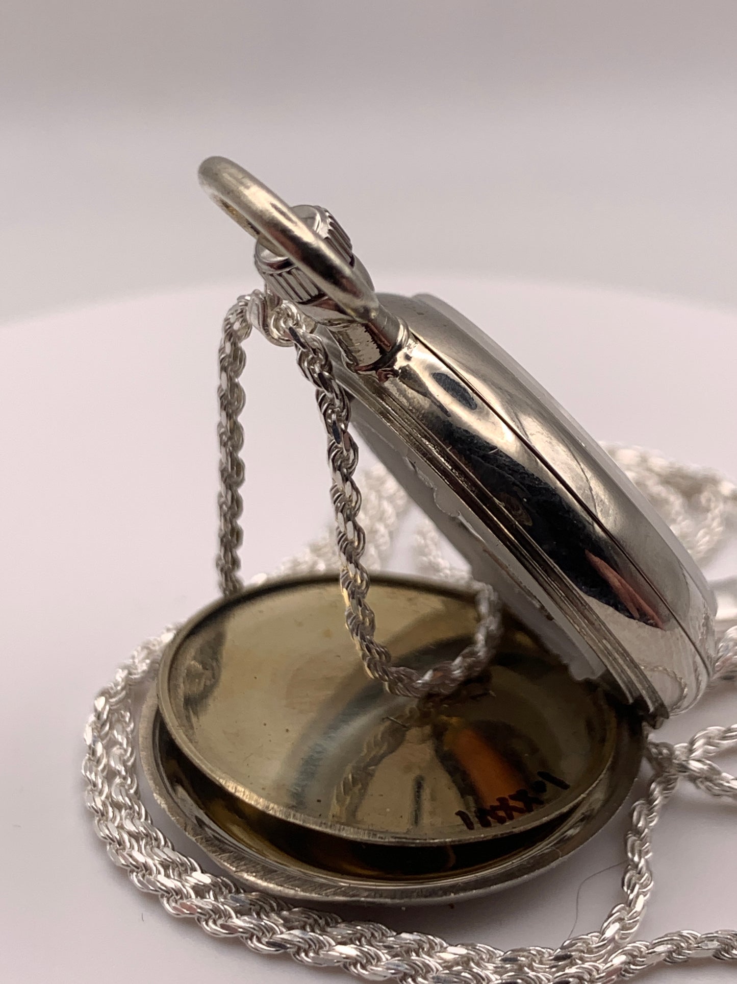 Amuse-bouche Deux. 30mm NOS Argentan alloy pocket / necklace watch. On a 24” 1.5mm sterling silver chain. Sapphire crystal. Vintage hand painted enamel dial. Miyota 2036.