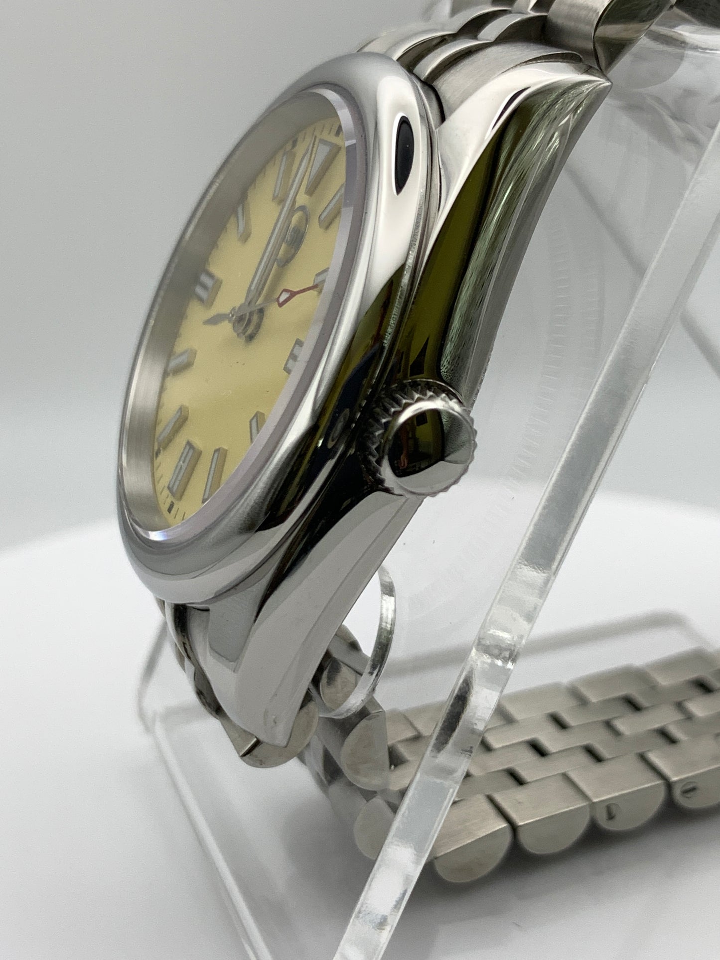 Pale yellow 36mm sport watch on bracelet.
