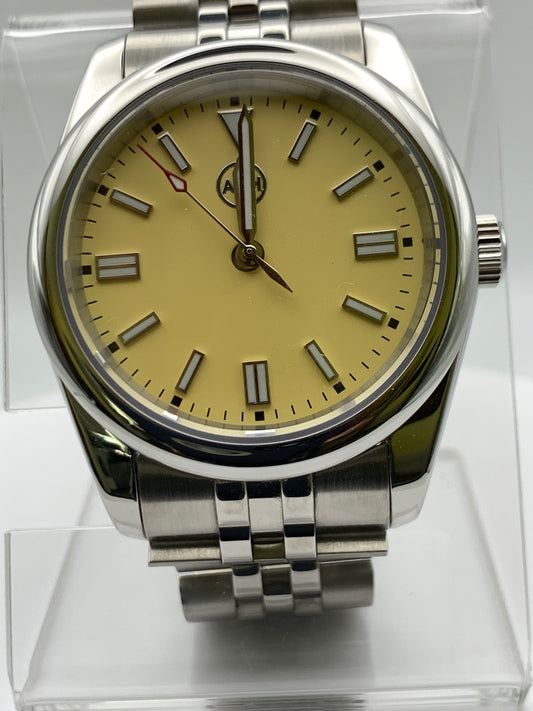 Pale yellow 36mm sport watch on bracelet.
