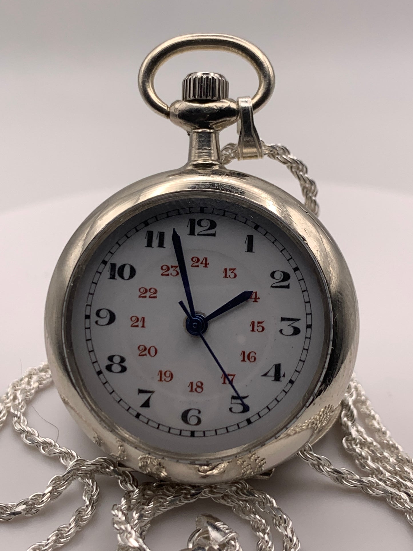 Amuse-bouche Deux. 30mm NOS Argentan alloy pocket / necklace watch. On a 24” 1.5mm sterling silver chain. Sapphire crystal. Vintage hand painted enamel dial. Miyota 2036.