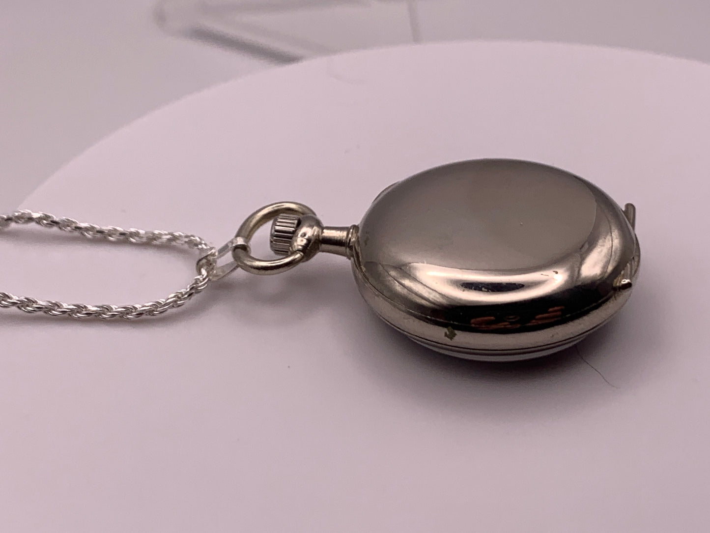 Amuse-bouche Deux. 30mm NOS Argentan alloy pocket / necklace watch. On a 24” 1.5mm sterling silver chain. Sapphire crystal. Vintage hand painted enamel dial. Miyota 2036.