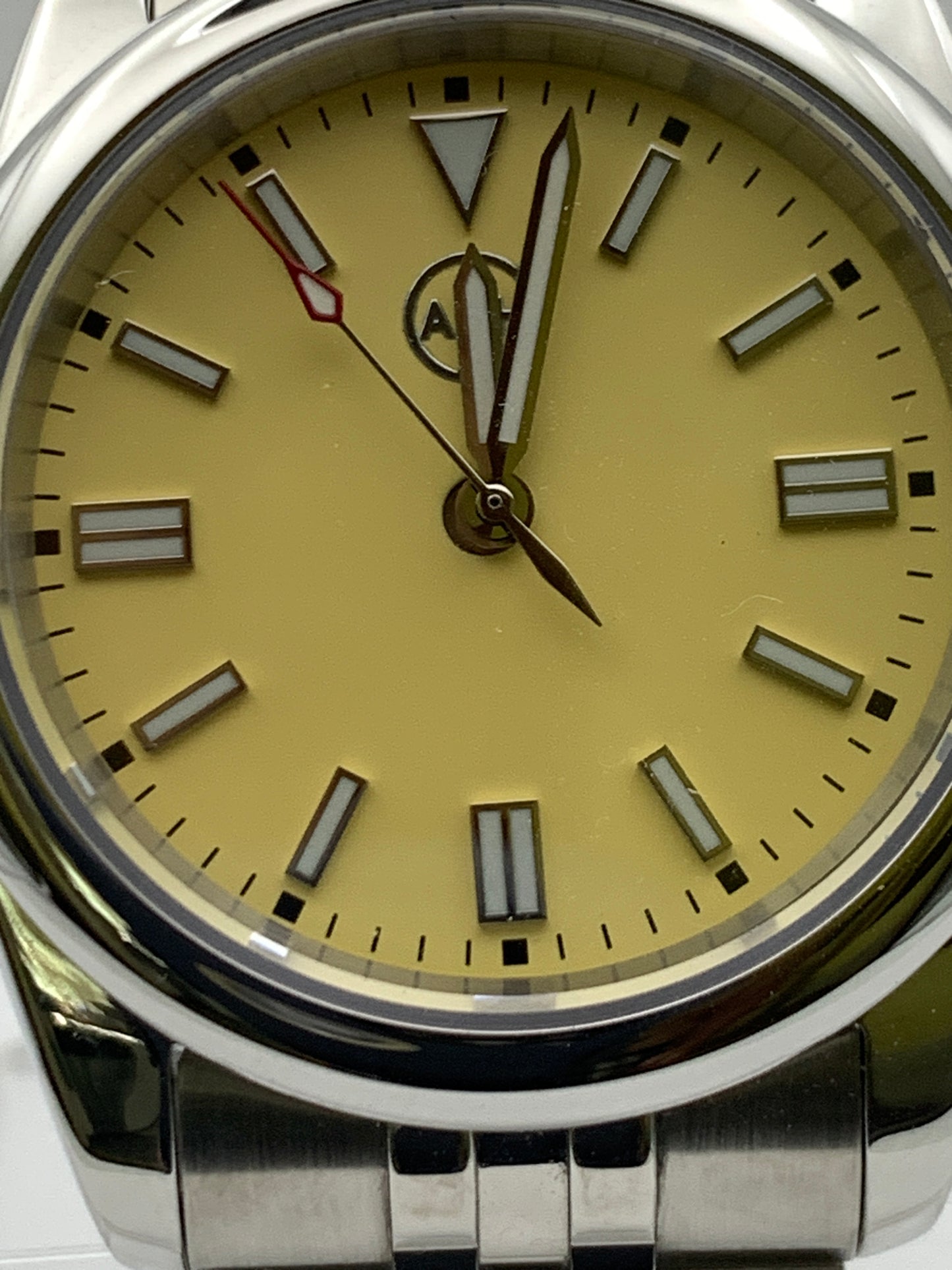 Pale yellow 36mm sport watch on bracelet.