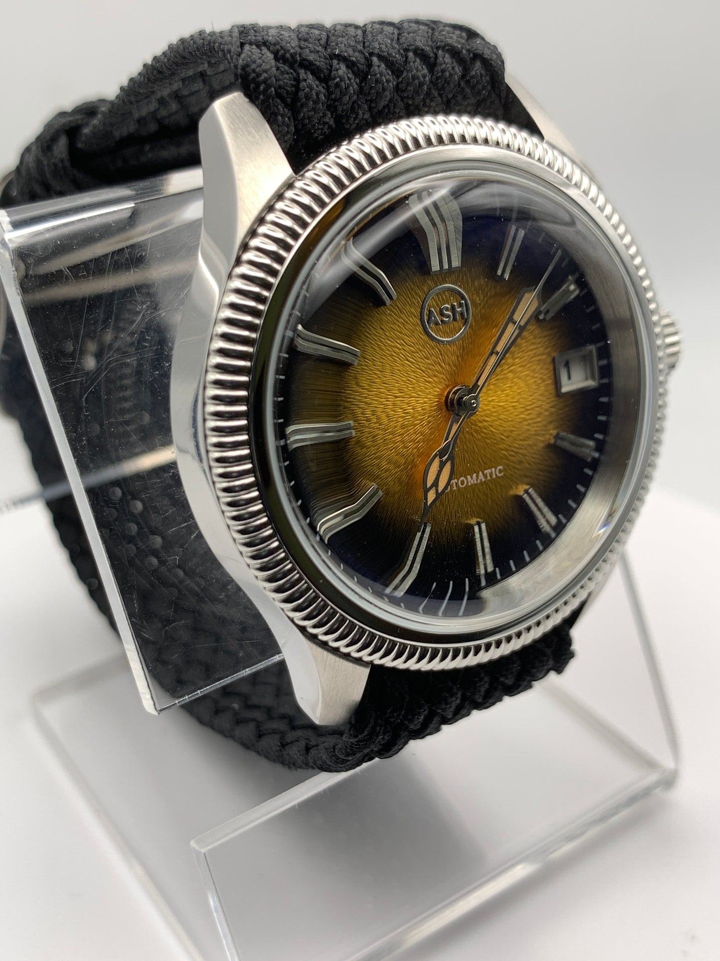 Homesick. 39mm Coin edged stainless steel case. Tobacco sunburst figured dial. AR coated domed mineral glass crystal. Seiko NH35 automatic movement.