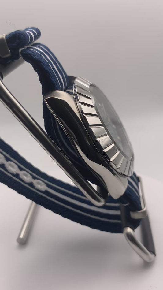 Pinwheel. 41mm Stainless steel case. Crystal titanium dial. Sapphire crystal. Unidirectional bezel. Seiko NH35.